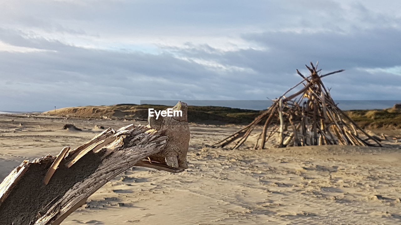 WOODEN LOGS AGAINST SKY