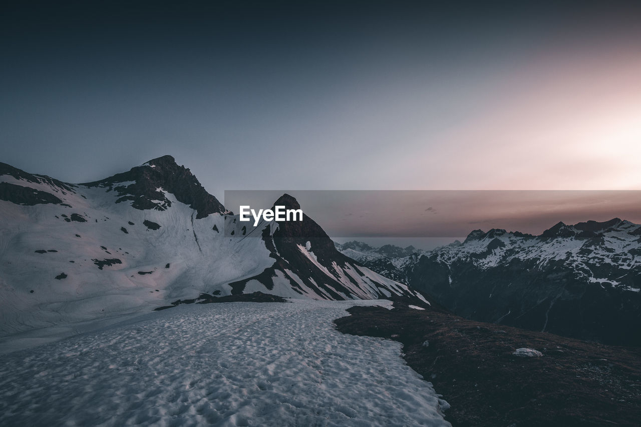 Scenic view of snowcapped mountains against sky