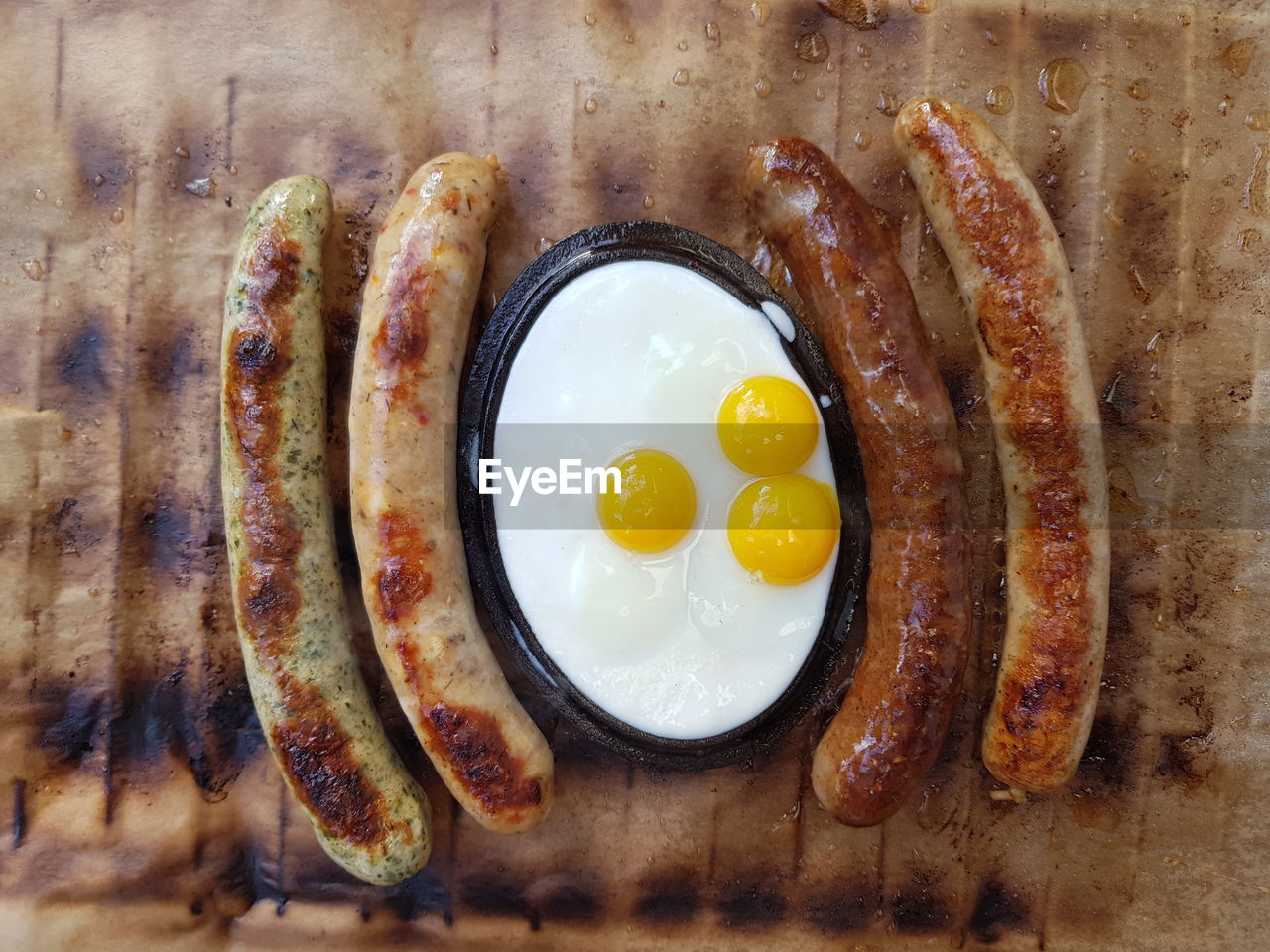 High angle view of sausages and quail eggs in plate