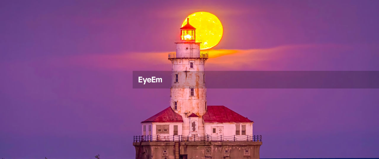 Lighthouse by sea against sky during sunset ,chicago city,usa