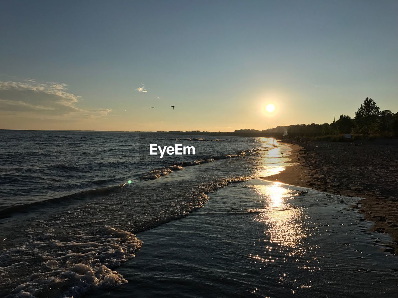 Scenic view of beach against sky during sunset
