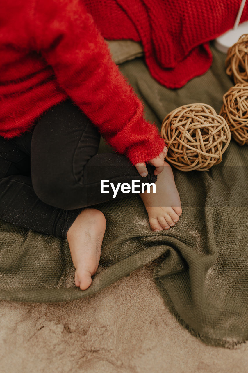 High angle view of baby sitting on floor