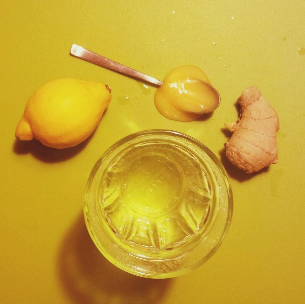 High angle view of lemon and ginger with bowl on table