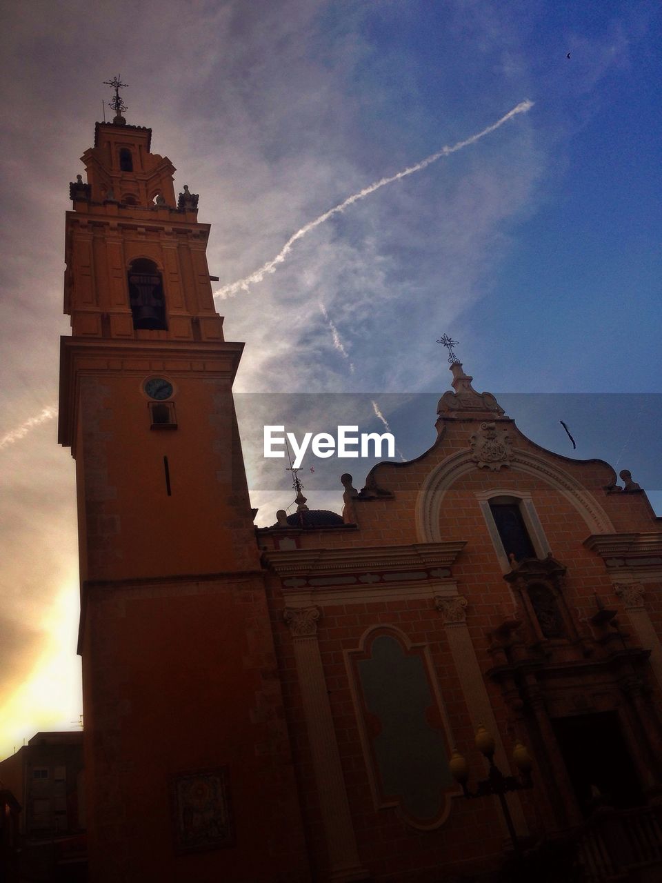 Low angle view of church against cloudy sky at dusk