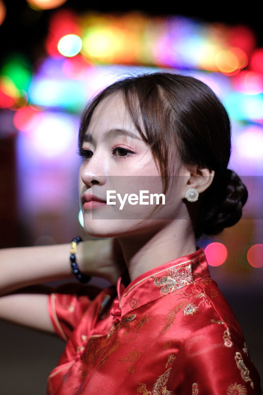 Portrait of beautiful asian woman wearing red dress in chinese new year festival.