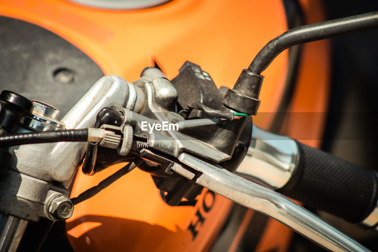 CLOSE-UP OF BICYCLE PARKED BY METAL