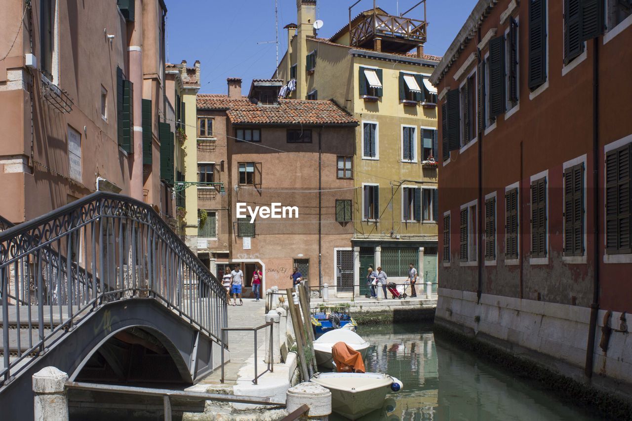 VIEW OF CANAL AMIDST BUILDINGS IN CITY