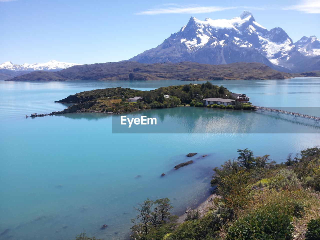 Scenic view of lake and mountains against sky