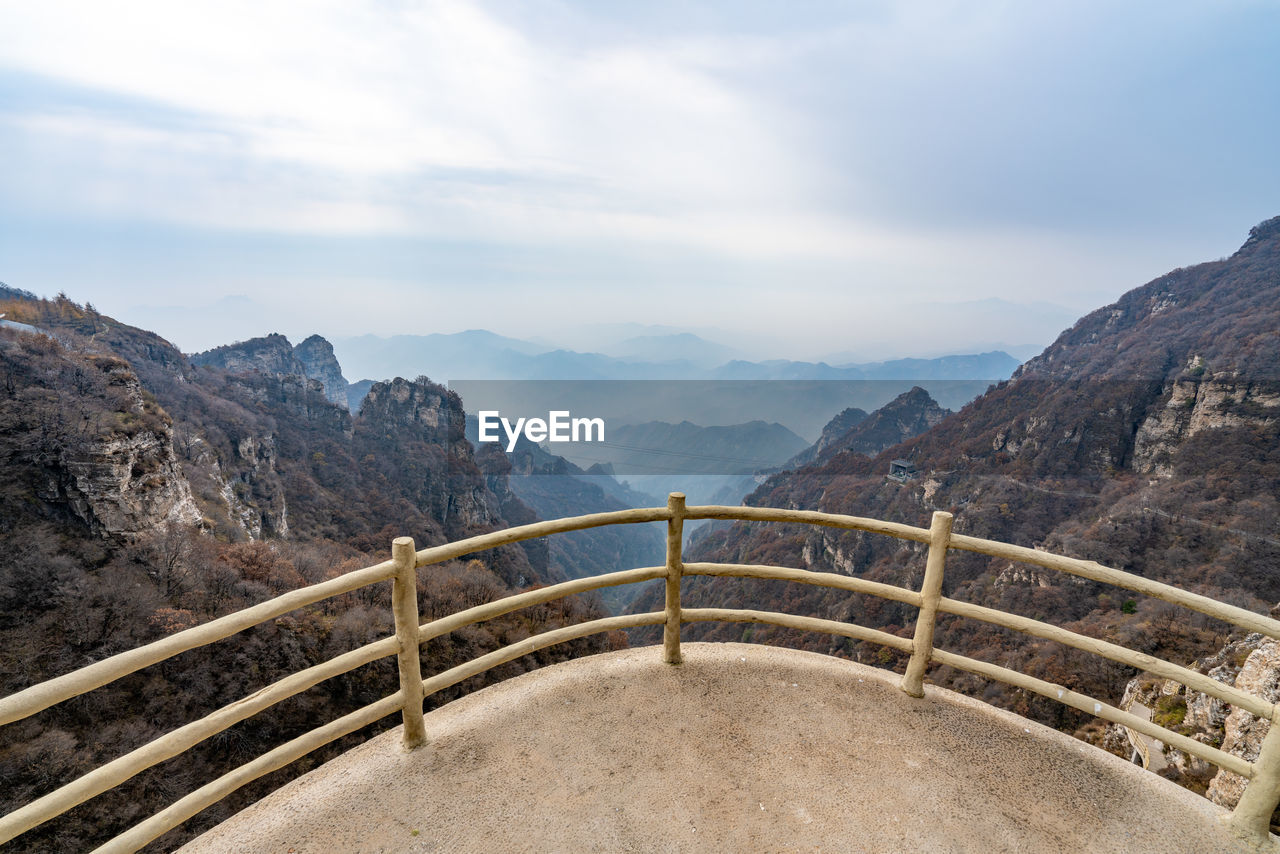 Scenic view of mountain against cloudy sky