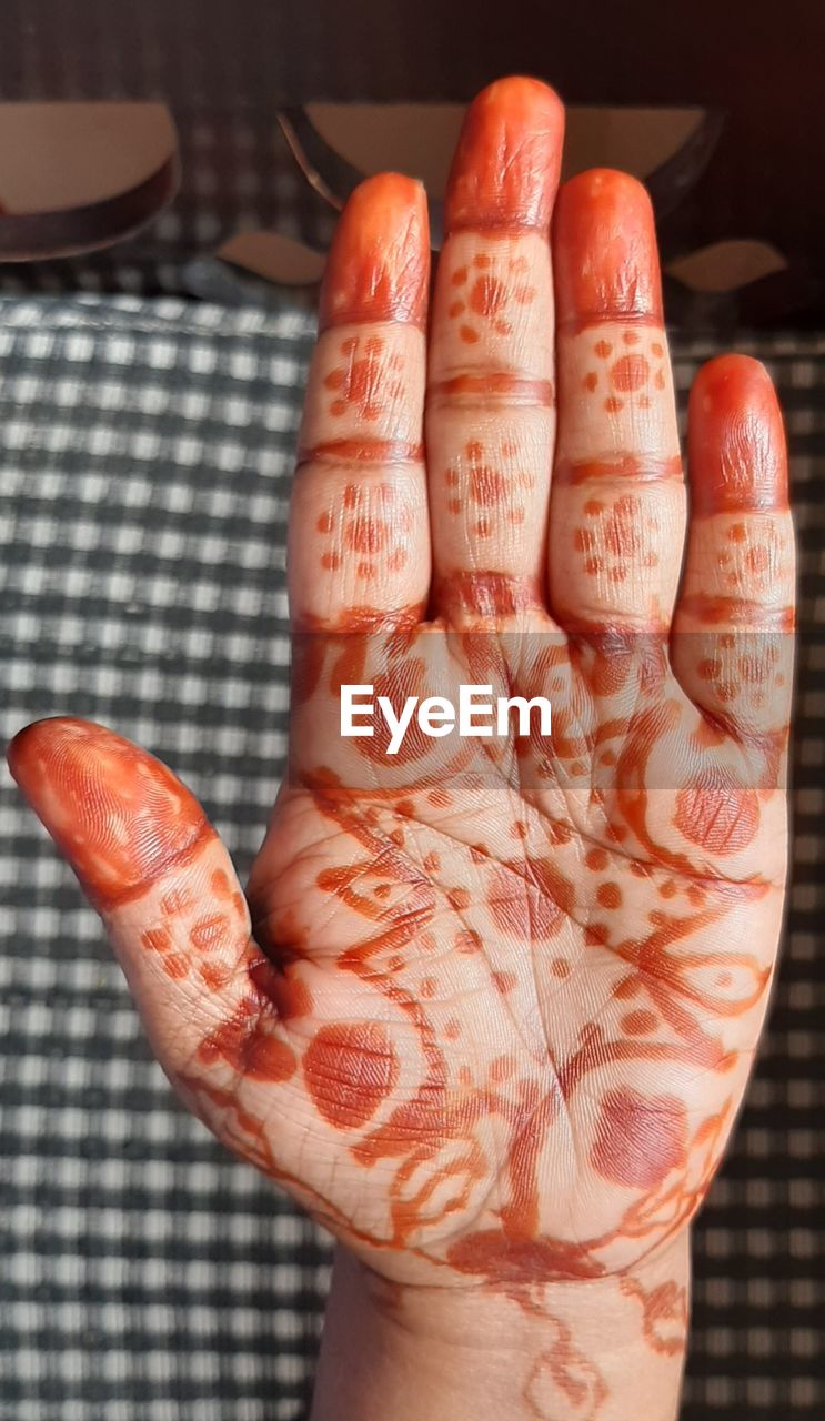 pattern, hand, finger, henna, one person, indoors, close-up, arm, henna tattoo, red, adult, nail, creativity, tattoo, limb, palm, orange color