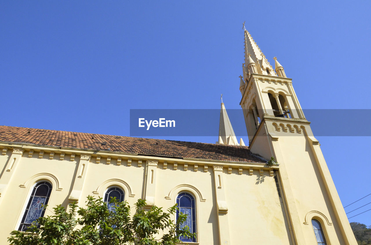 Low angle view of church against blue sky