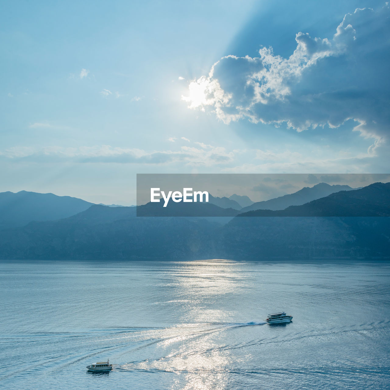 View of sea by mountains against sky