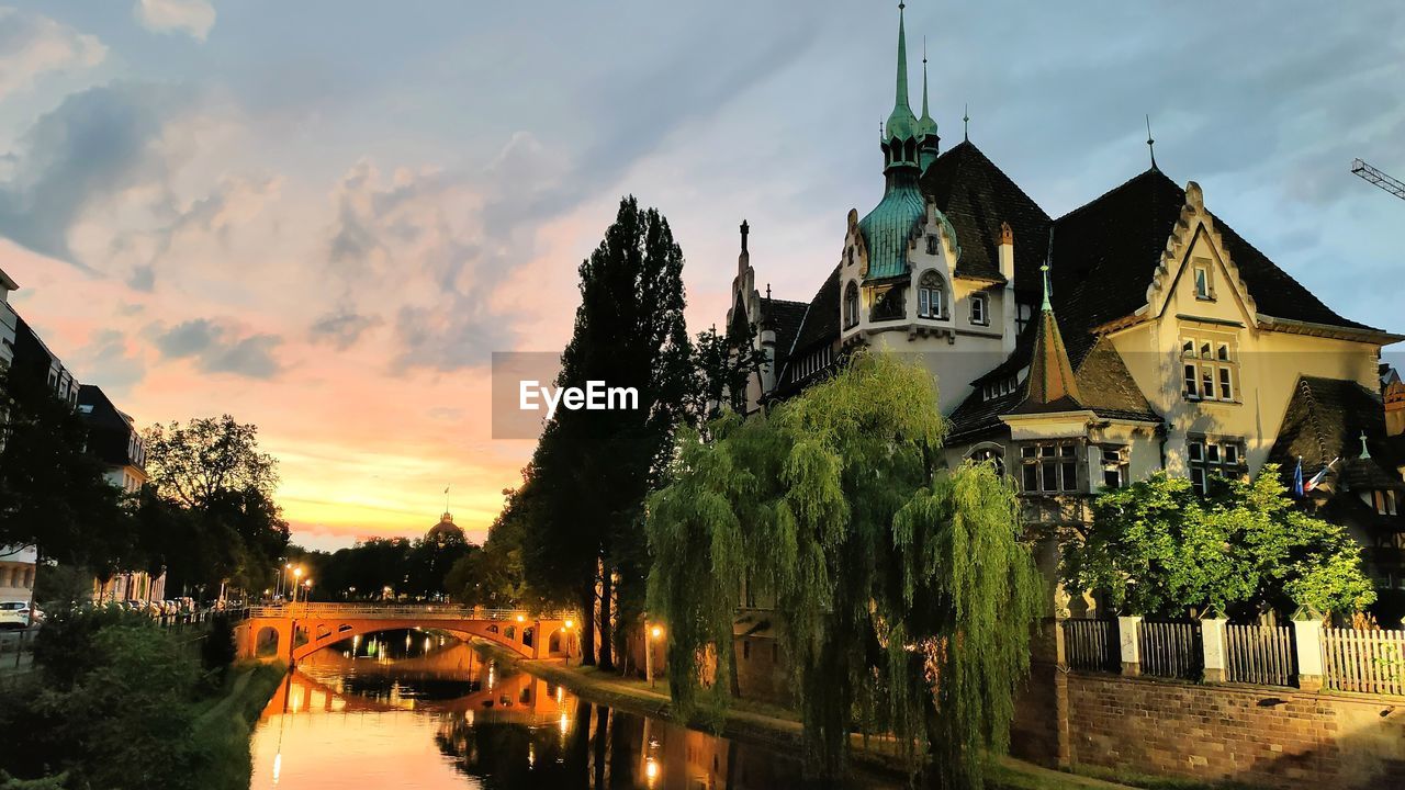 architecture, built structure, sky, building exterior, nature, building, tree, cloud, plant, water, travel destinations, sunset, cityscape, evening, city, religion, history, place of worship, the past, travel, dusk, no people, landmark, reflection, outdoors, tourism, belief, bridge, transportation, river, tower, house, night