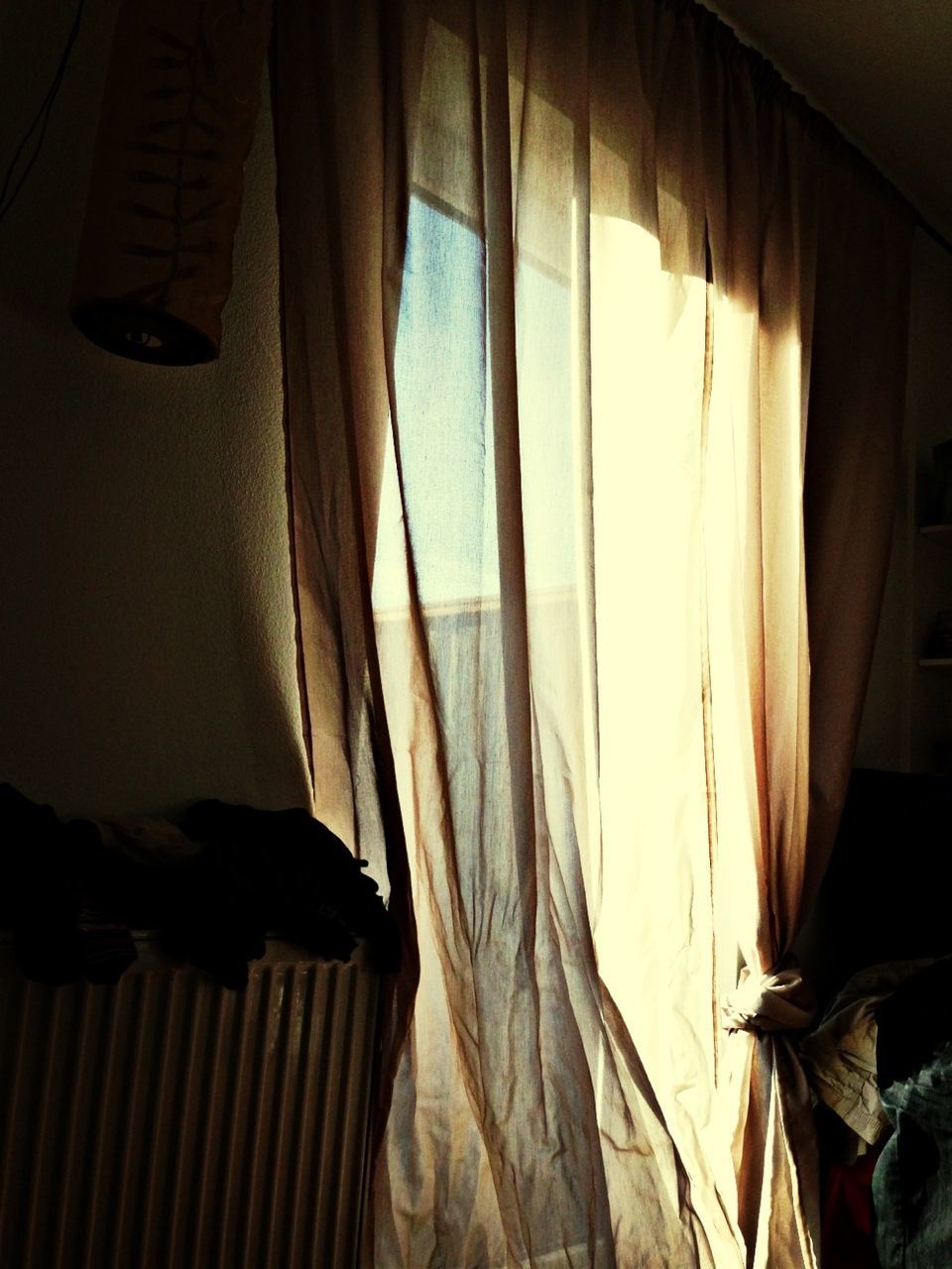 Sunlight falling on curtain at home