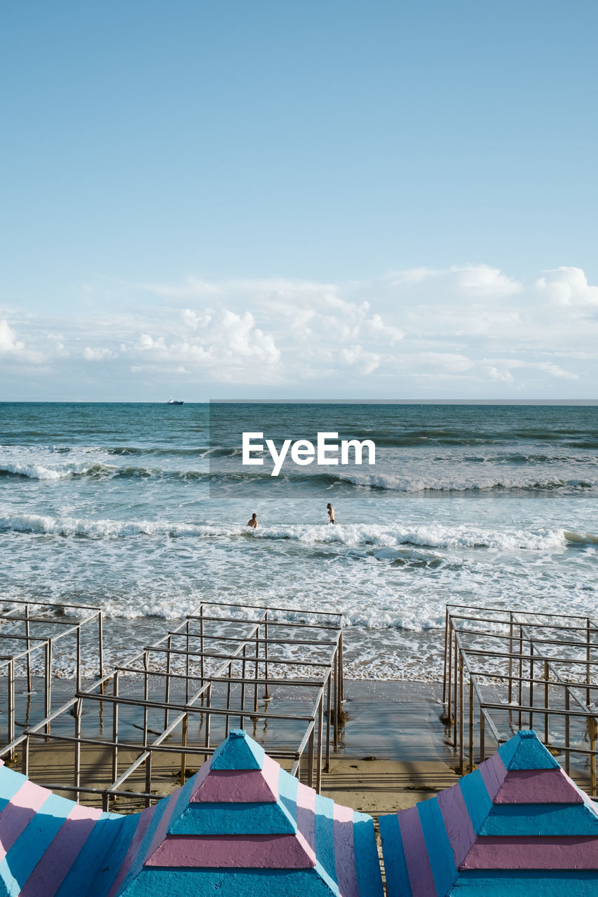 SCENIC VIEW OF BEACH BY SEA AGAINST SKY