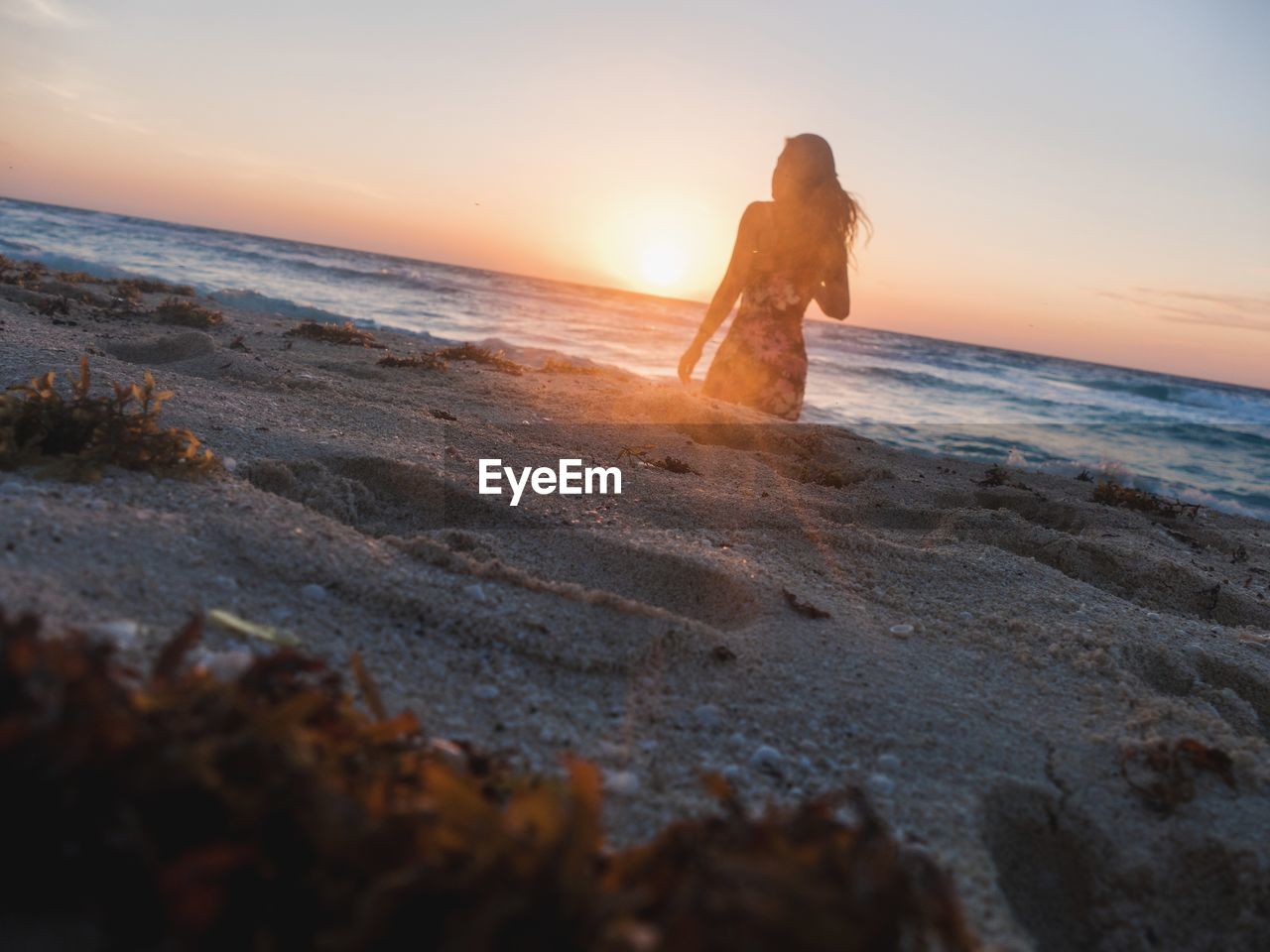 Silhouette of woman on a beach at sunset