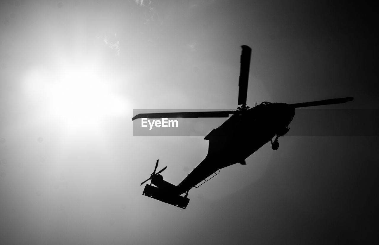 LOW ANGLE VIEW OF SILHOUETTE HELICOPTER AGAINST SKY