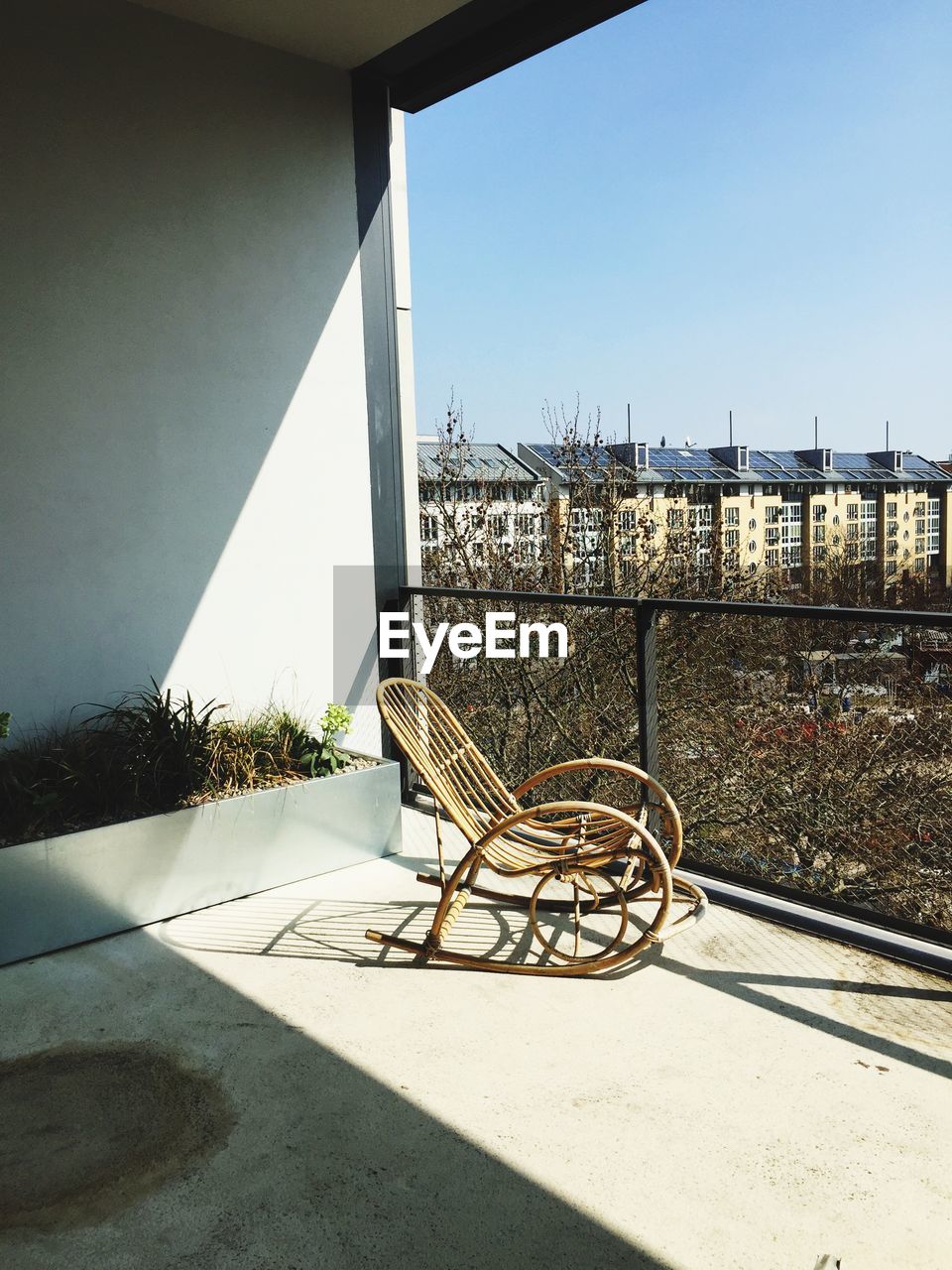 Rocking chair in balcony against clear sky