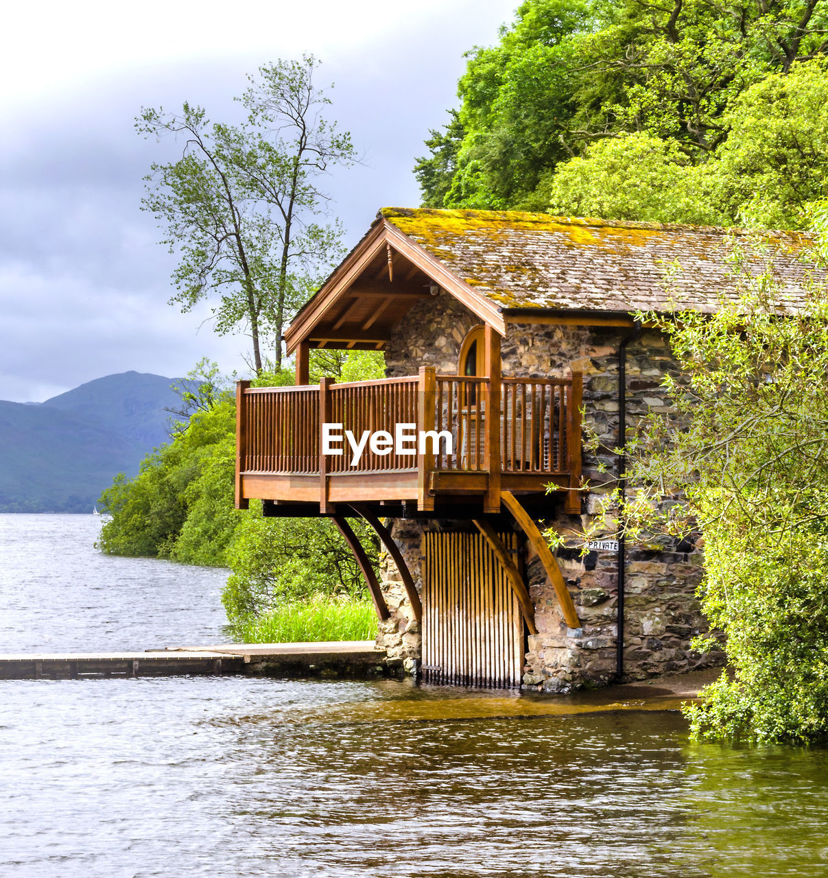 HOUSE BY RIVER AGAINST TREES