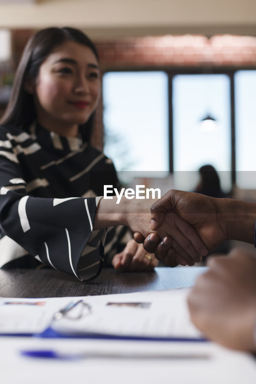 Business colleagues shaking hands in office