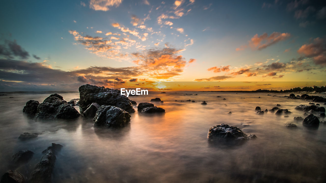 Scenic view of sea at sunset