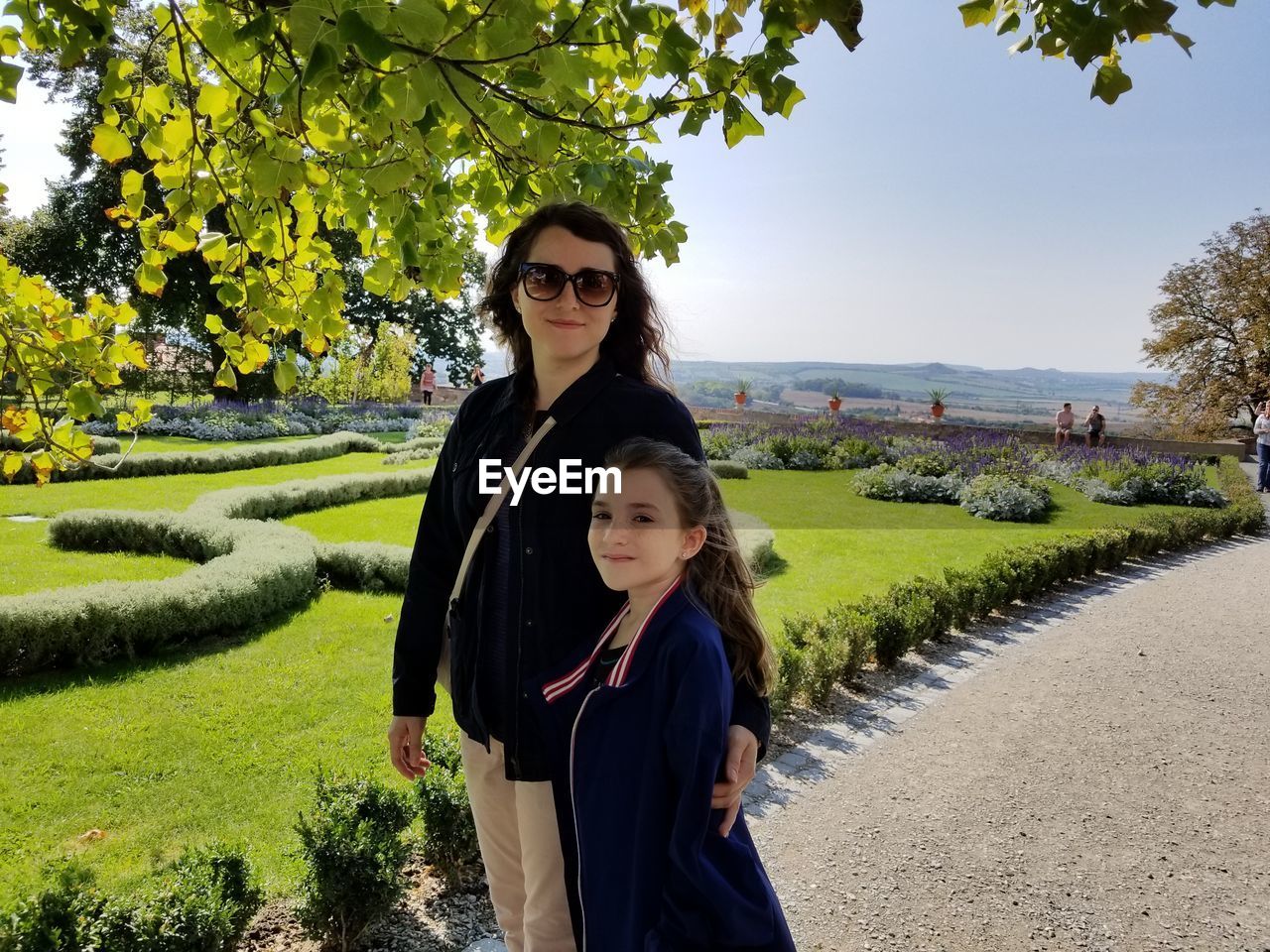 Portrait of mother and daughter standing in park