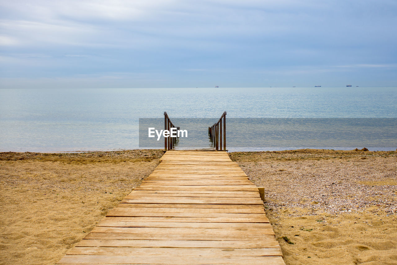 WOODEN PIER LEADING TOWARDS SEA