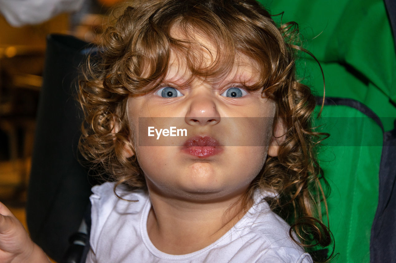 Close-up portrait of girl with curly hair