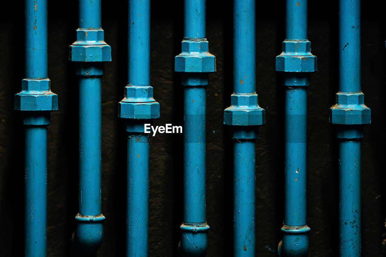 Close-up of blue pipelines at night