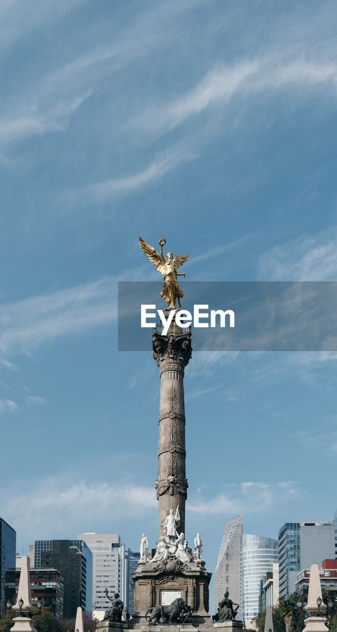 Low angle view of victory column against cloudy sky