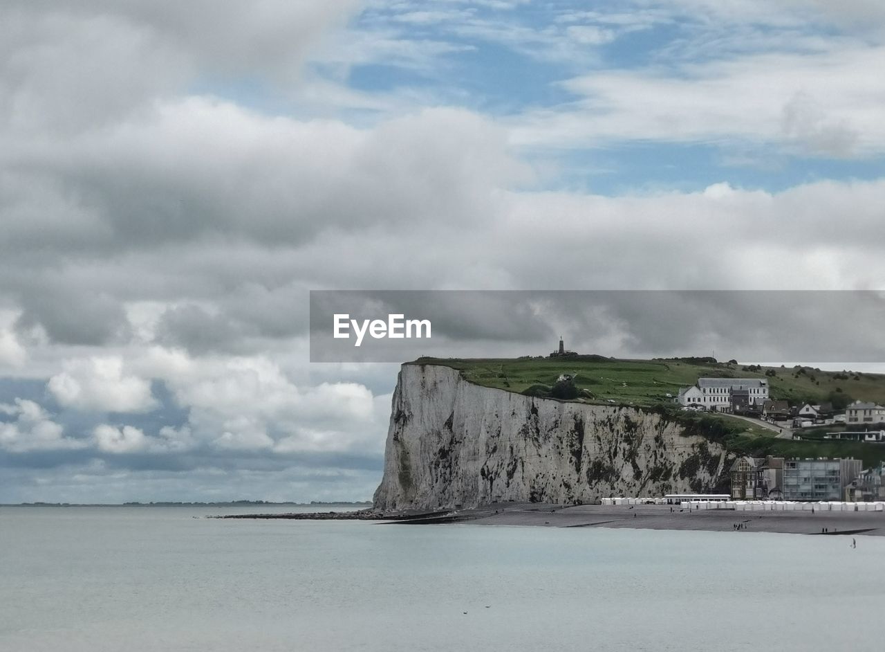 SCENIC VIEW OF BEACH AGAINST CLOUDY SKY