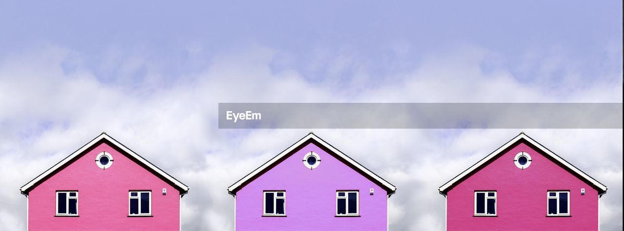 low angle view of building against cloudy sky