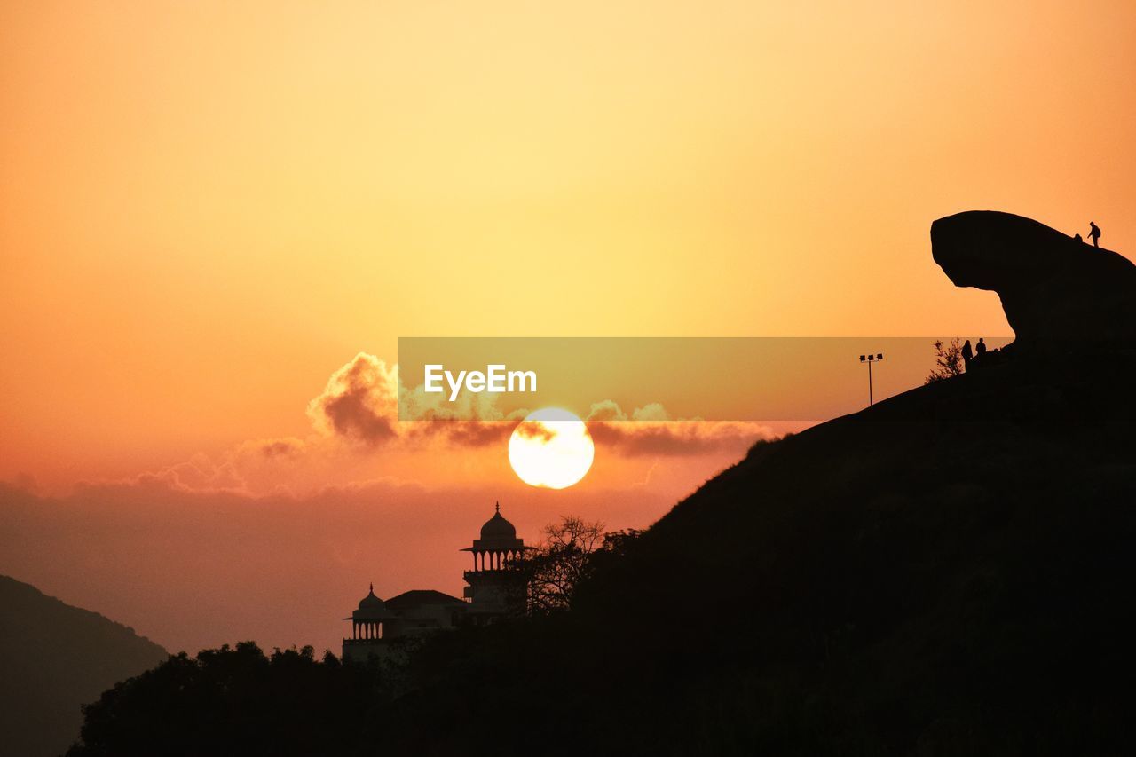 SILHOUETTE BUILDING AGAINST SKY DURING SUNSET