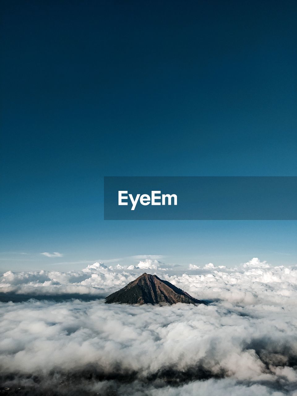 Scenic view of snowcapped mountains against blue sky