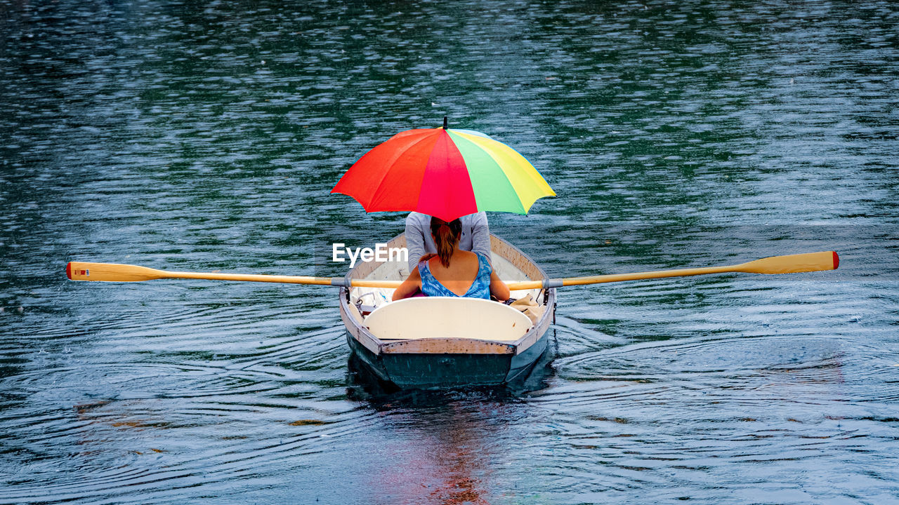 WOMAN WITH UMBRELLA ON BOAT