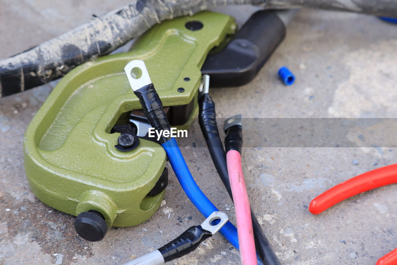 HIGH ANGLE VIEW OF TOOLS ON METAL TABLE