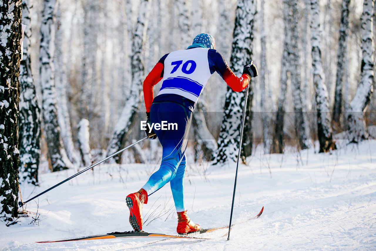 Man skiing on snow covered land