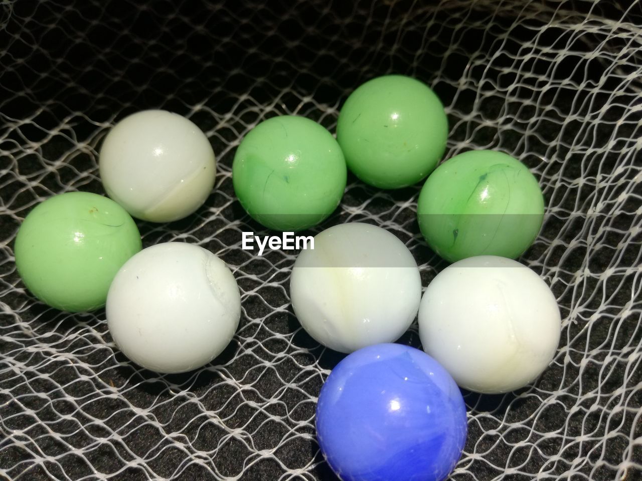 HIGH ANGLE VIEW OF MULTI COLORED EGGS ON GREEN
