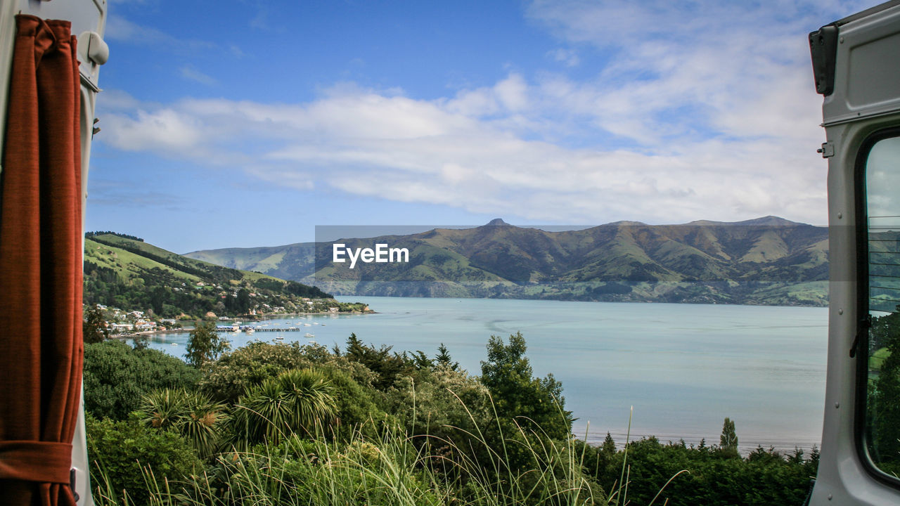 Scenic view of lake and mountains against sky