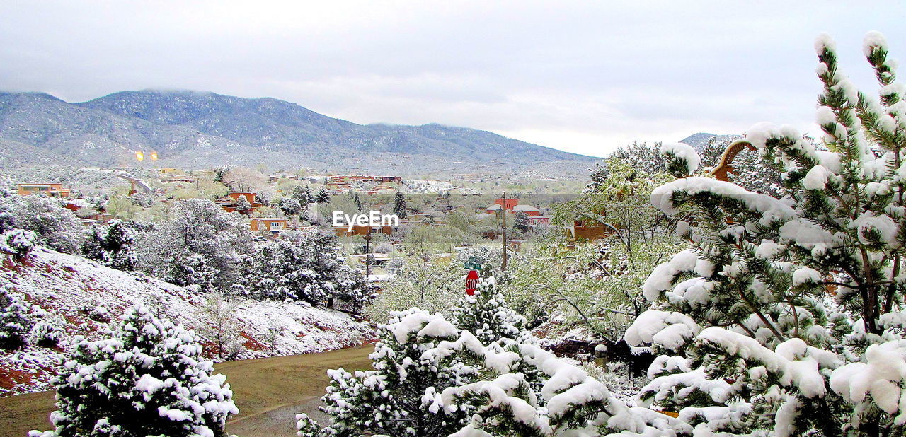 Scenic view of snow covered mountains against sky