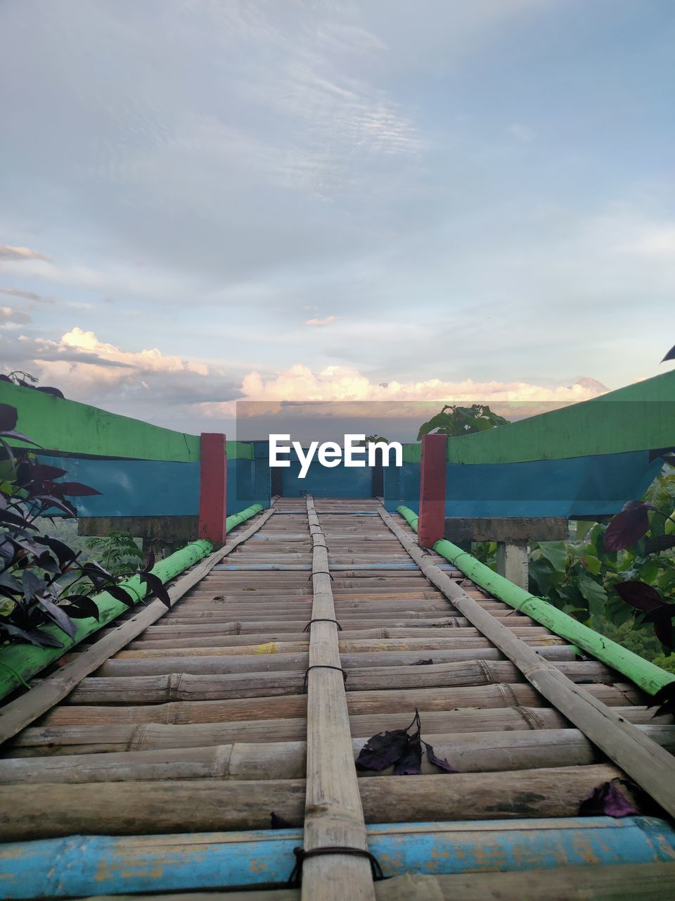 Wooden pier over sea against sky