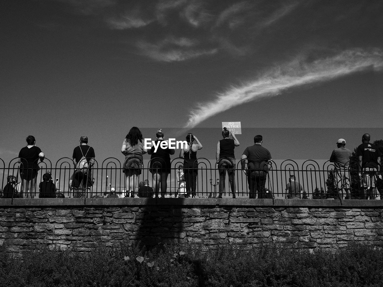 PEOPLE ON SIDEWALK AGAINST SKY