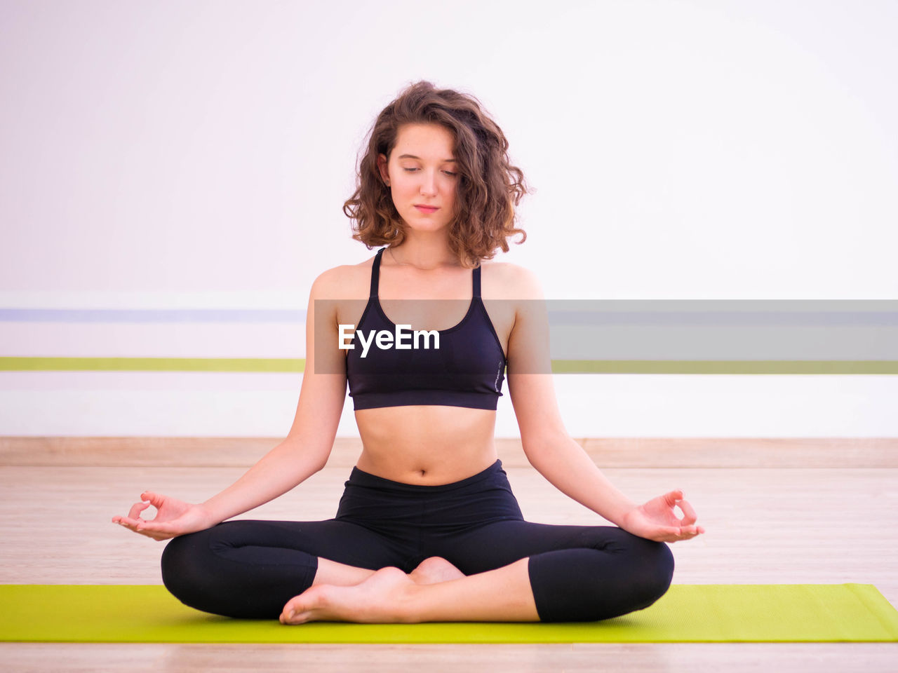 Young woman meditating in yoga studio