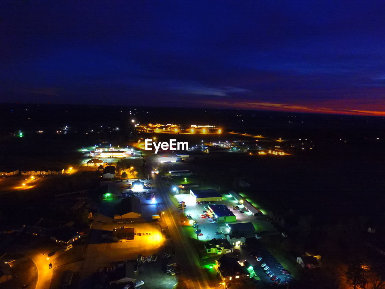 High angle view of illuminated cityscape against sky at night