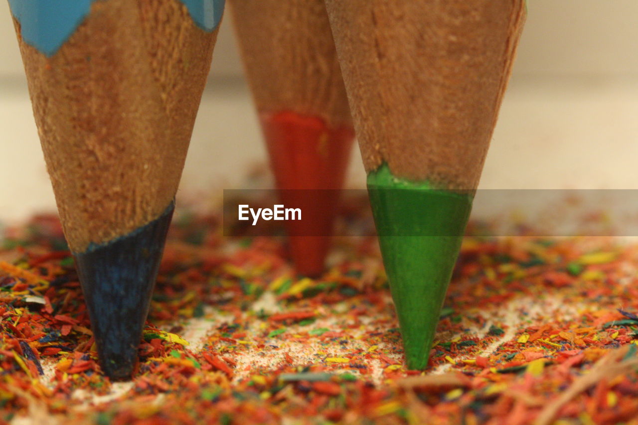 Close-up of colored pencils on shavings