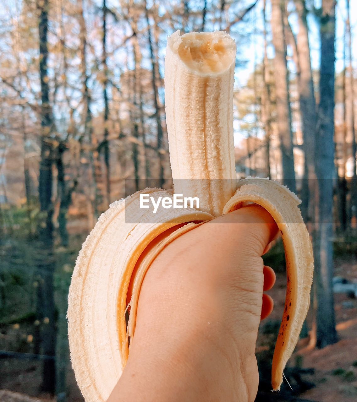 Woman holding a ripe banana