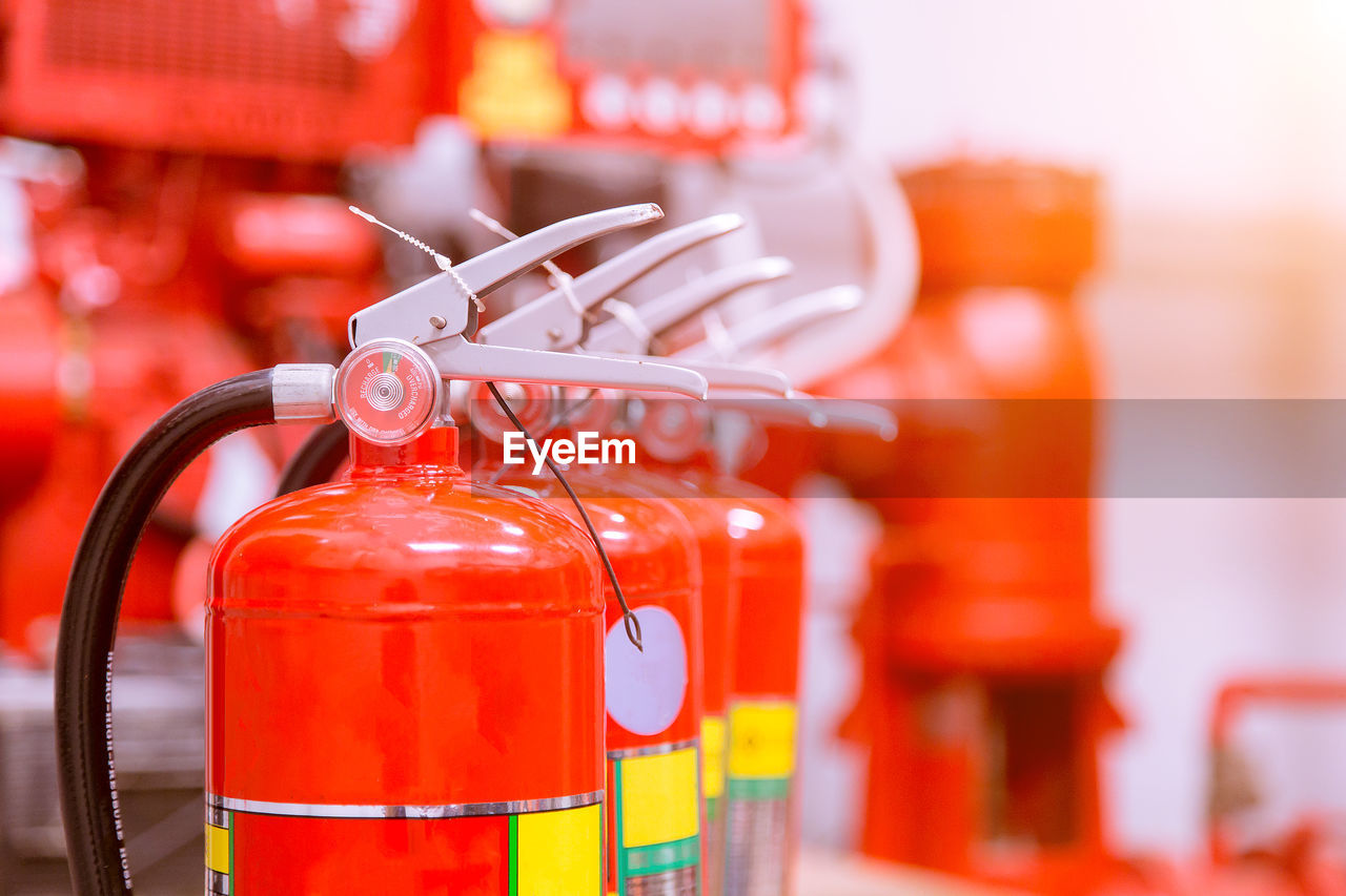 Red tank of fire extinguisher overview of a powerful industrial fire extinguishing system.