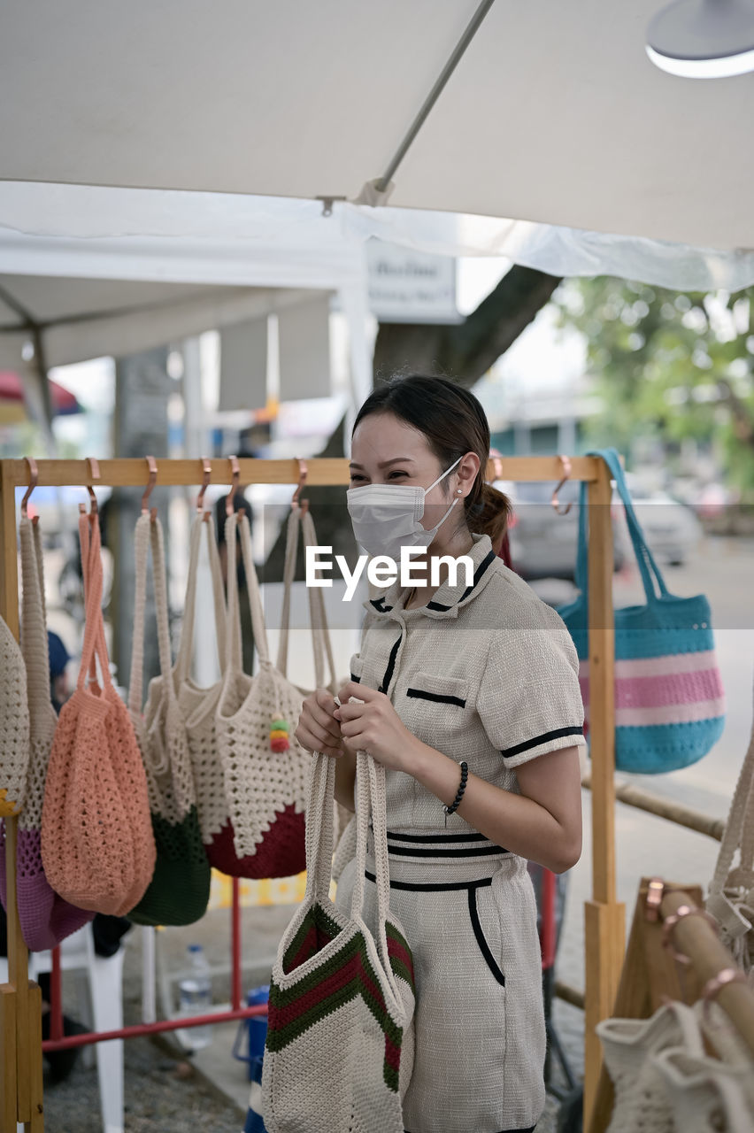 Series photo of young women choosing new shopping bag in street market , refreshing look concept