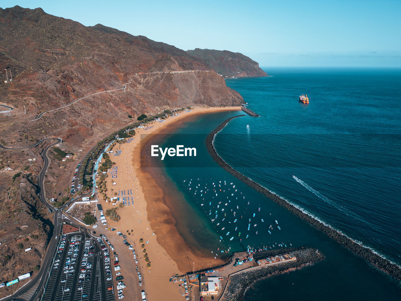 water, coast, sea, land, beach, nature, aerial photography, transportation, aerial view, scenics - nature, high angle view, bay, travel destinations, environment, landscape, beauty in nature, travel, sky, no people, architecture, ocean, terrain, body of water, blue, coastline, outdoors, city, cliff, road, shore, mode of transportation, horizon, day, tourism, mountain, tranquility, nautical vessel, industry