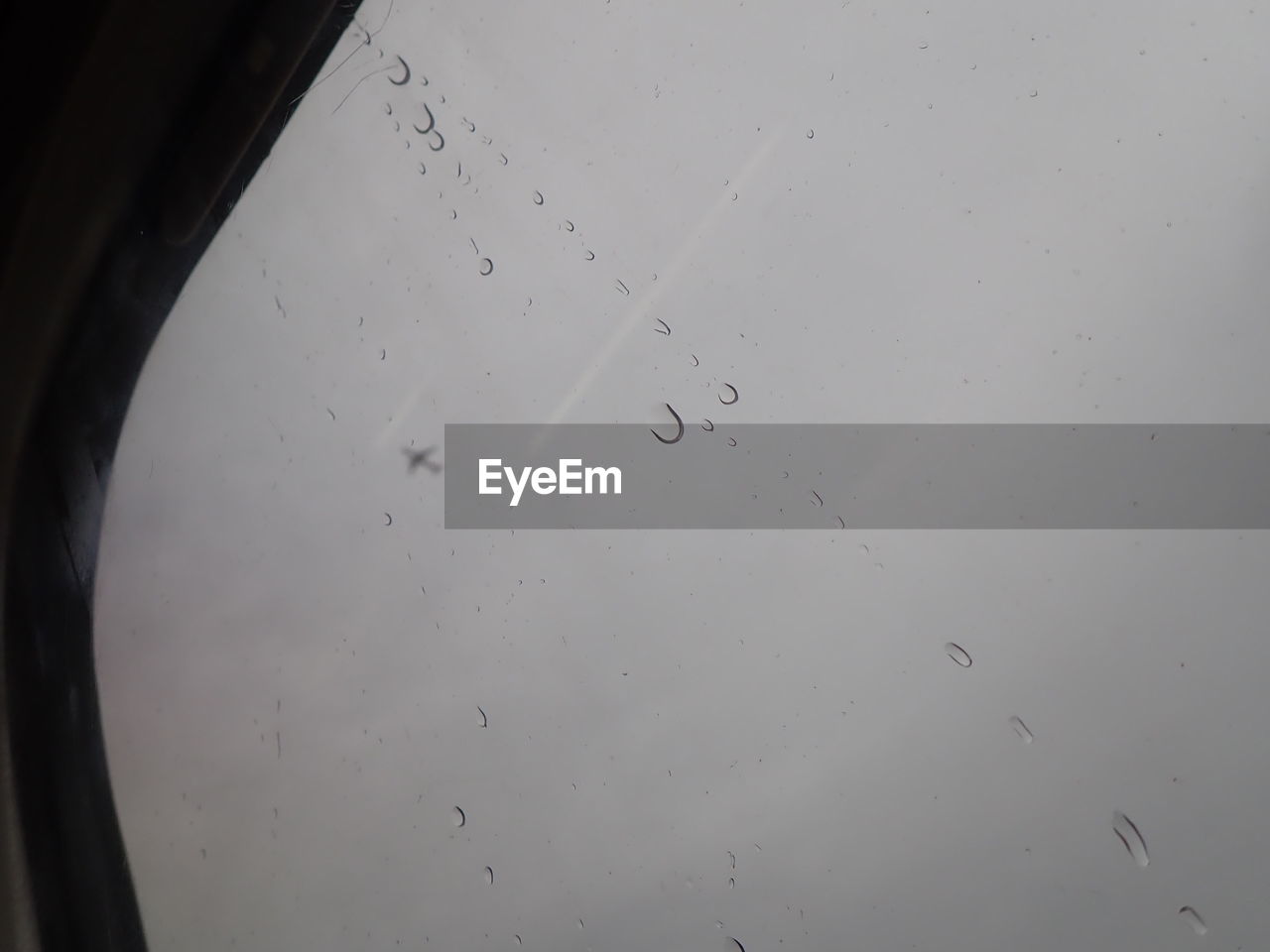 LOW ANGLE VIEW OF RAINDROPS ON WINDOW